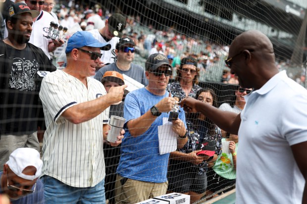 Former Chicago White Sox pitcher José Contreras gives fans fist bumps before the game against the Cleveland Guardians at Rate Field on Sunday, July 13, 2025. (Eileen T. Meslar/Chicago Tribune)