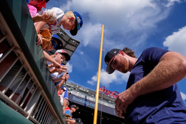 Chicago White Sox pitcher Shane Smith signs autographs before the MLB baseball All-Star Home Run Derby, Monday, July 14, 2025, in Atlanta. (AP Photo/Brynn Anderson)