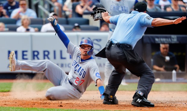 Chicago Cubs' Seiya Suzuki (27) scores a run during the seventh inning of a baseball game against the New York Yankees, Sunday, July 13, 2025, in New York. (AP Photo/Noah K. Murray)