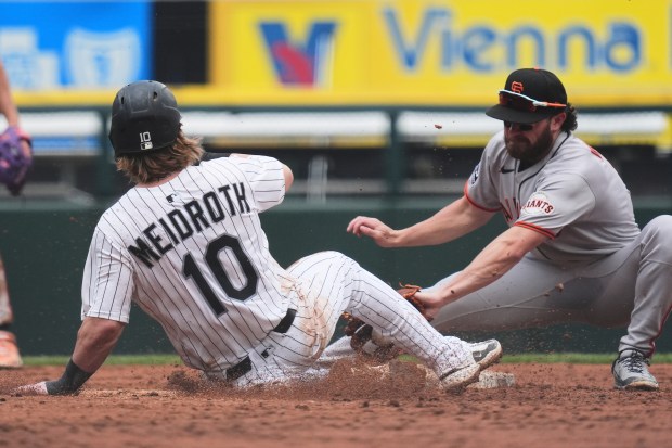 Chicago White Sox's Chase Meidroth, left, steals second against San Francisco Giants second baseman Brett Wisely during the fifth inning of a baseball game in Chicago, Sunday, June 29, 2025. (AP Photo/Nam Y. Huh)