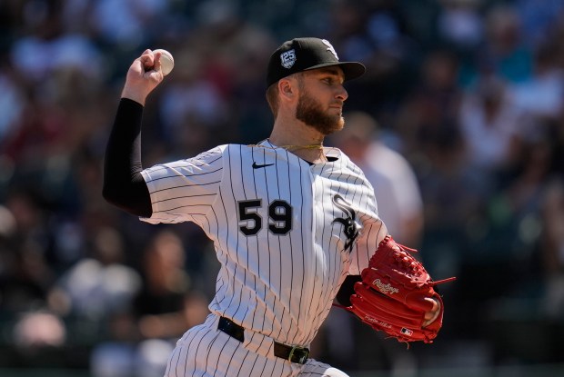 Chicago White Sox starting pitcher Sean Burke (59) throws against the Cleveland Guardians during the first inning of a baseball game Saturday, July 12, 2025, in Chicago. (AP Photo/Erin Hooley)