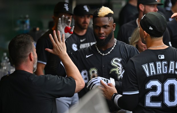 White Sox center fielder Luis Robert Jr. high-fives teammates in the dugout after hitting a solo home run in the fourth inning against the Pirates on July 18, 2025, in Pittsburgh. (Justin Berl/Getty Images)