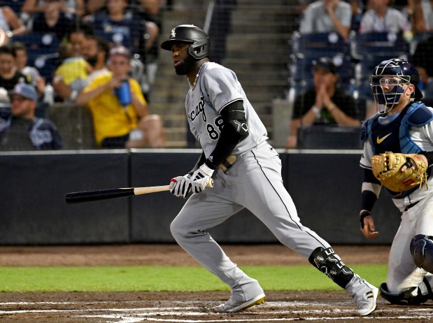 Chicago White Sox's Luis Robert Jr. watches his two-run single during the third inning of a baseball game against the Tampa Bay Rays, Monday, July 21, 2025, in Tampa, Fla. (AP Photo/Jason Behnken)