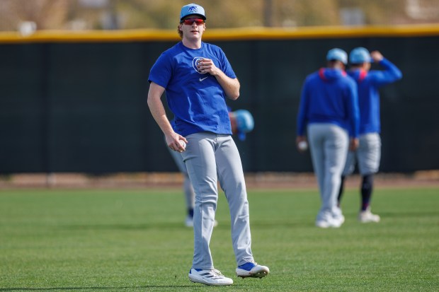 Cubs outfielder Owen Caissie runs drills with other players on the first day of full-squad workouts during spring training at Sloan Park on Feb. 14, 2025, in Mesa, Ariz. (Armando L. Sanchez/Chicago Tribune)