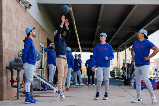 Cubs shortstop Dansby Swanson, President Jed Hoyer, outfielder Pete Crow-Armstrong and infielder Nicky Lopez laugh while playing basketball on the first day of full-squad workouts during spring training at Sloan Park on Feb. 14, 2025, in Mesa, Ariz. (Armando L. Sanchez/Chicago Tribune)