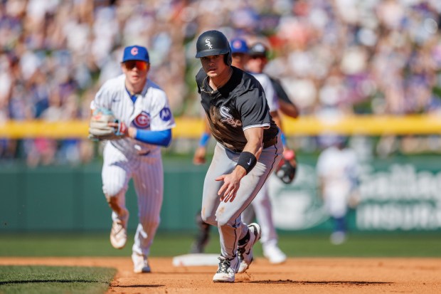 Chicago White Sox designated hitter Bobby Dalbec (32) runs between second and first base before being tagged out by Chicago Cubs catcher Carson Kelly (15) during the fourth inning at spring training at Sloan Park Saturday Feb. 22, 2025, in Mesa, Arizona. (Armando L. Sanchez/Chicago Tribune)