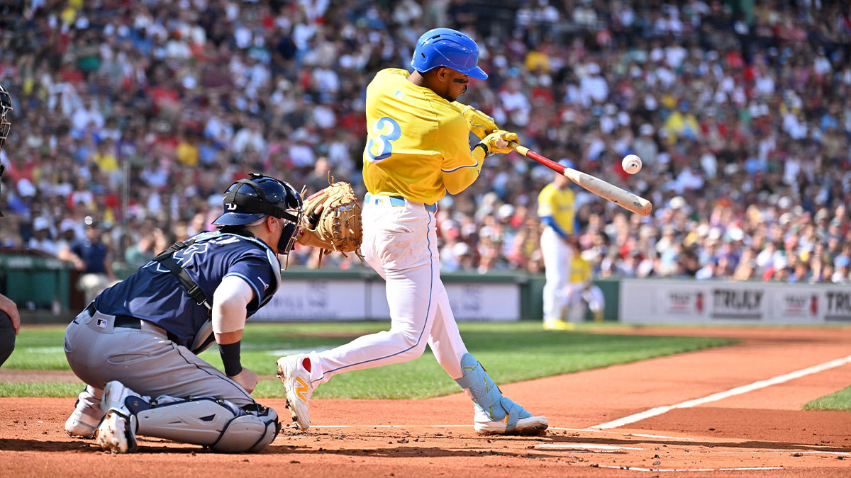 Boston Red Sox second baseman Ceddanne Rafaela (3) hits a single against the Tampa Bay Rays during the first inning at Fenway Park. 