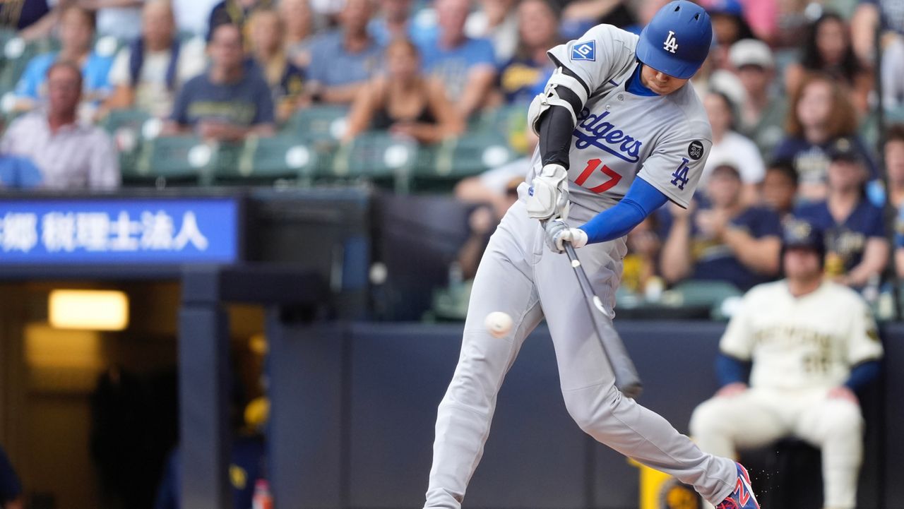 Los Angeles Dodgers' Shohei Ohtani hits a solo home run during the first inning of a baseball game against the Milwaukee Brewers, Tuesday, July 8, 2025, in Milwaukee. (AP Photo/Aaron Gash)