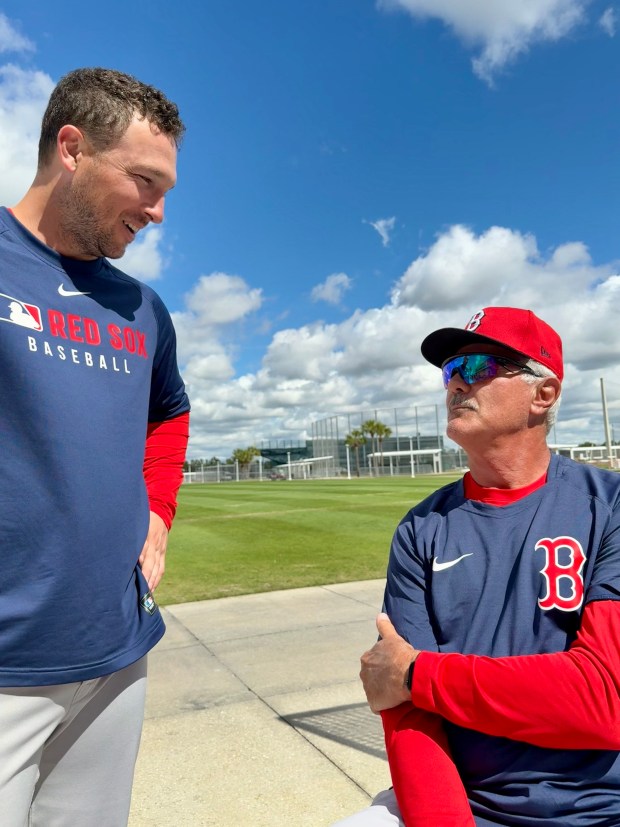 Boston Red Sox infielder Alex Bregman, left, talks baseball at spring training with former Red Sox outfielder Dwight Evans. (Herald photo Gabrielle Starr)