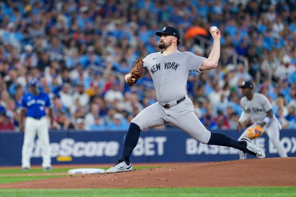 New York Yankees pitcher Carlos Rodon throws against the Toronto Blue Jays during first-inning baseball game action in Toronto, Monday, June 30, 2025. (Thomas Skrlj/The Canadian Press via AP)