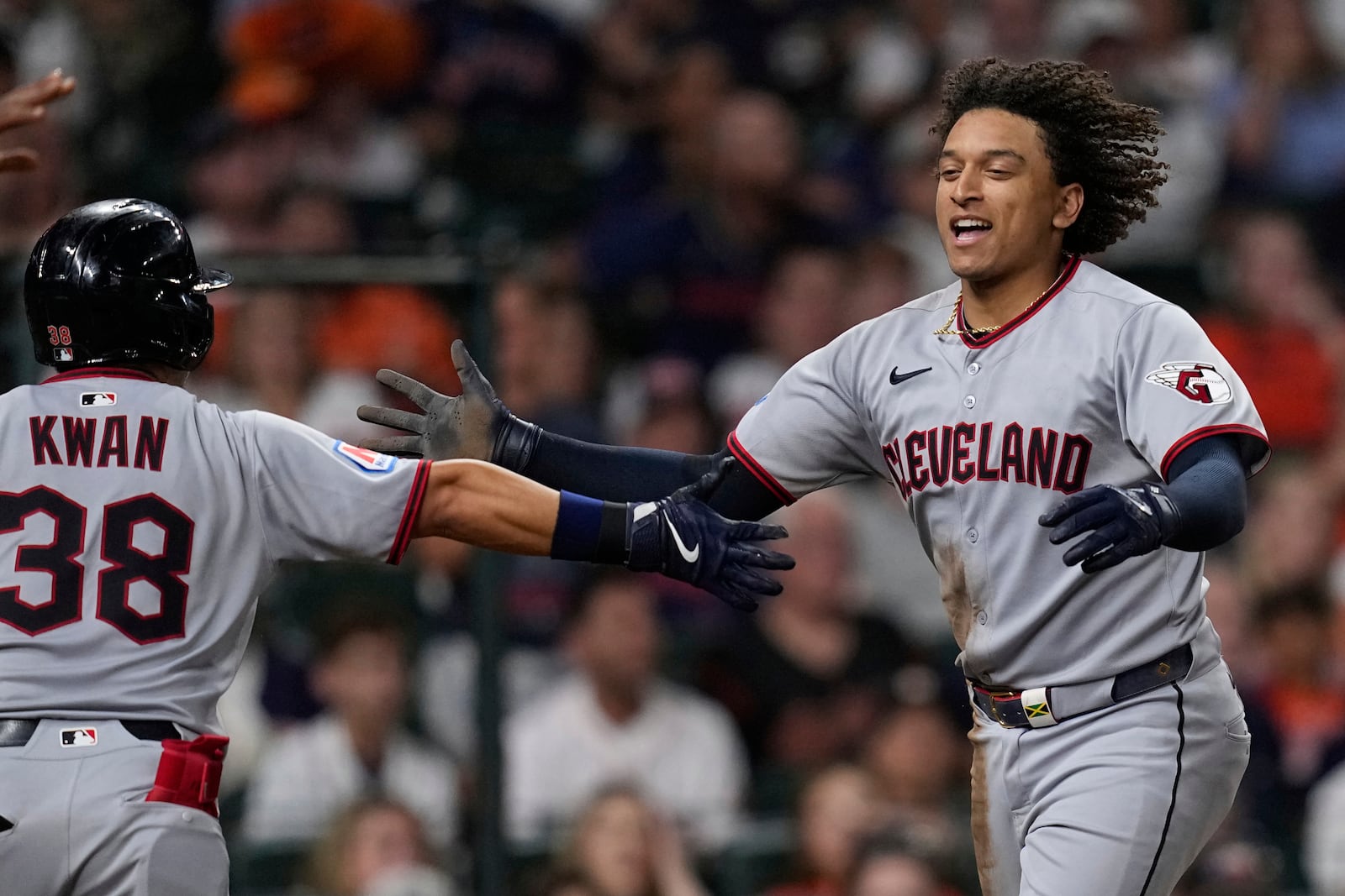 Cleveland Guardians' Bo Naylor, right, celebrates with Steven Kwan (38) after scoring against the Houston Astros during the sixth inning of a baseball game Monday, July 7, 2025, in Houston. (AP Photo/David J. Phillip)
