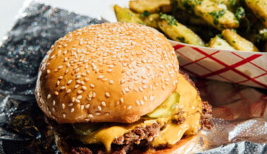 A cheeseburger on a foil wrapper