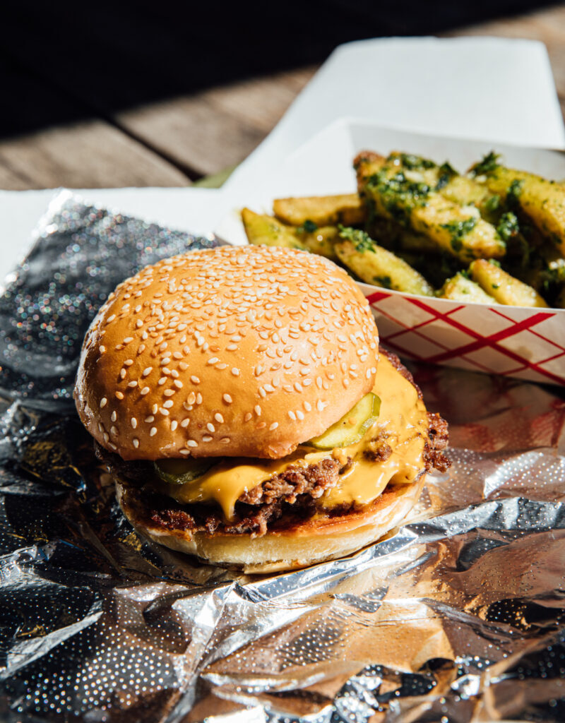 A cheeseburger on a foil wrapper