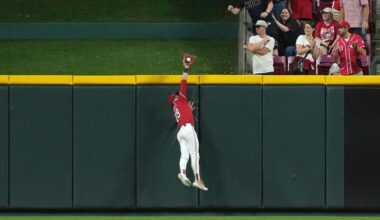 Cincinnati Reds' TJ Friedl catches a fly ball at the wall to end the game in the ninth inning of a baseball game against the Milwaukee Brewers, Tuesday, June 3, 2025, in Cincinnati. (AP Photo/Kareem Elgazzar)