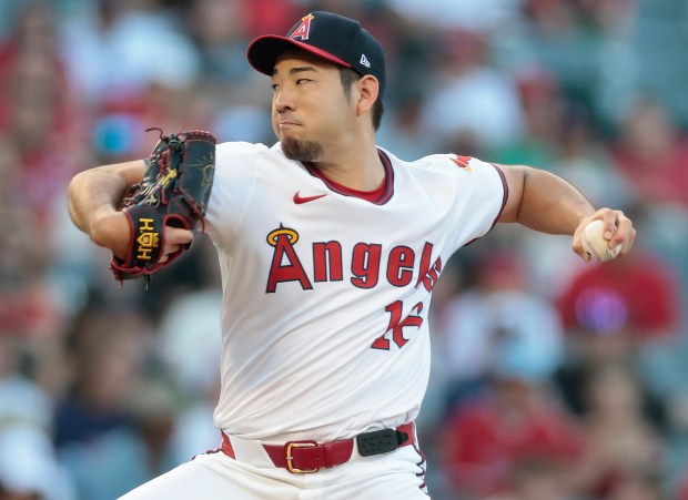 Angels starting pitcher Yusei Kikuchi throws to the plate during...