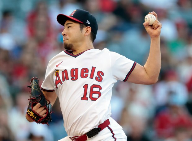 Angels starting pitcher Yusei Kikuchi throws to the plate during...