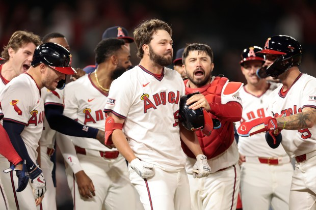 The Angels’ Nolan Schanuel (18) celebrates with teammates after he...