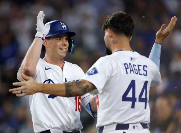 The Dodgers’ Will Smith, left, celebrates with teammate Andy Pages...