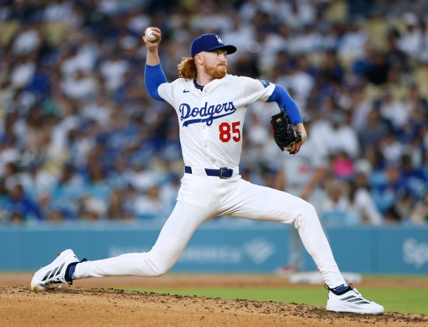 Dodgers relief pitcher Dustin May throws to the plate during...