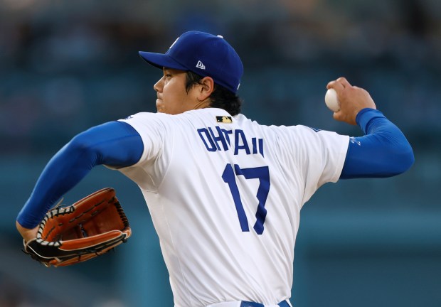 Dodgers starting pitcher Shohei Ohtani throws to the plate during...