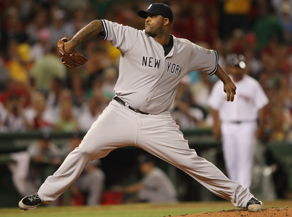 CC Sabathia #52 of the New York Yankees delivers a pitch in the first inning against the Boston Red Sox on August 23, 2009 at Fenway Park in Boston, Massachusetts.  
