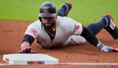 Cleveland Guardians' Carlos Santana slides safely into third base on a hit by Lane Thomas in the first inning of a baseball game against the Detroit Tigers in Cleveland, Friday, July 4, 2025.