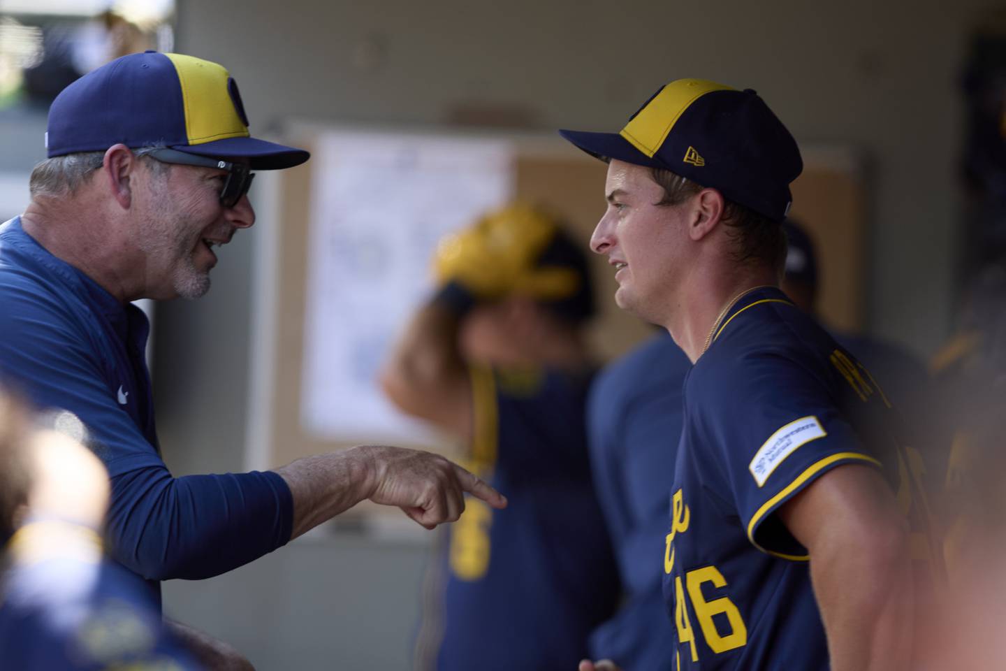 Milwaukee Brewers pitching coach Chris Hook, left, talks with starting pitcher Quinn Priester after working seventh inning in a baseball game against the Seattle Mariners, Wednesday, July 23, 2025, in Seattle. (AP Photo/John Froschauer)
