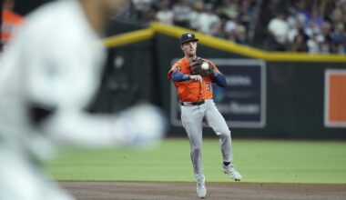Houston Astros shortstop Zack Short, right, throws to first base to get Arizona Diamondbacks' Lourdes Gurriel Jr. out during the first inning of a baseball game Tuesday, July 22, 2025, in Phoenix. (AP Photo/Ross D. Franklin)
