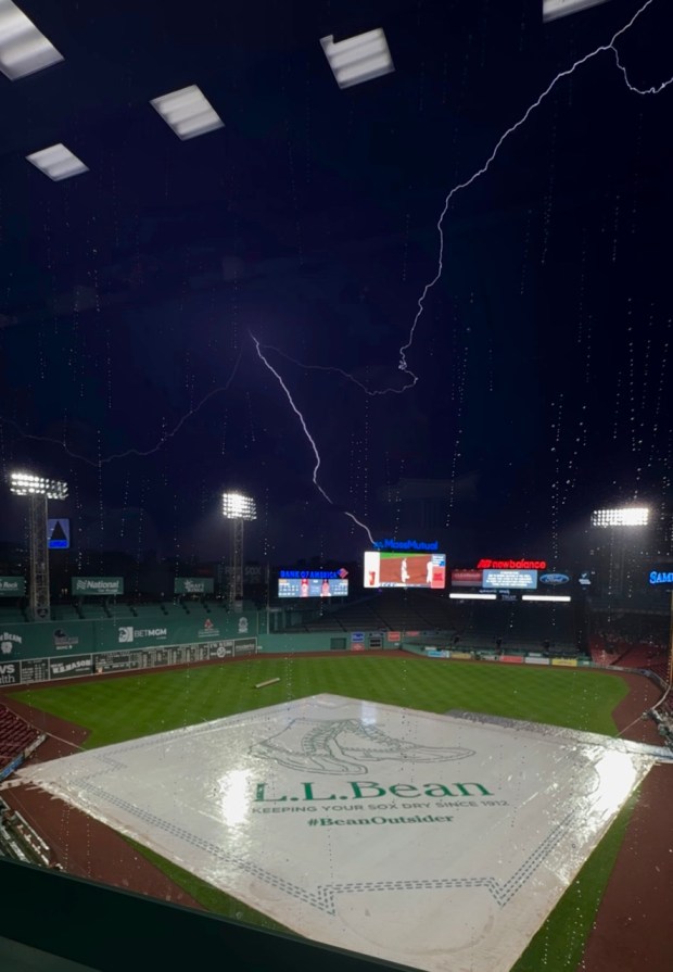 Lightning lights up Fenway Park as the Boston Red Sox and Cincinnati Reds game Tuesday night gets suspended. (Gabrielle Starr/Boston Herald)