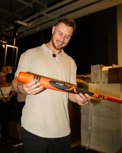 Orioles first baseman Ryan O'Hearn admires the Victus bat with signatures of players from the Newtown Edgmont Angels.