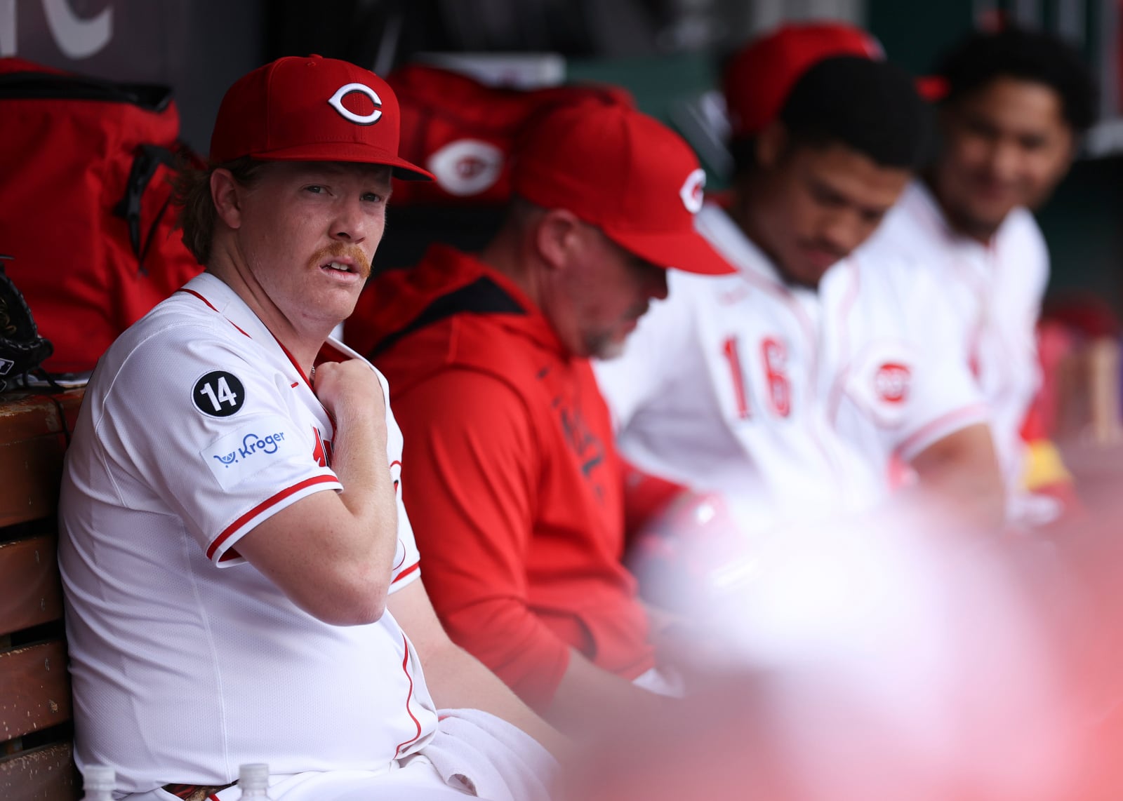 Cincinnati Reds pitcher Andrew Abbott, left, looks on from the dugout during the first inning of a baseball game against the St. Louis Cardinals, Thursday, May 1, 2025, in Cincinnati. (AP Photo/Abdoul Sow)