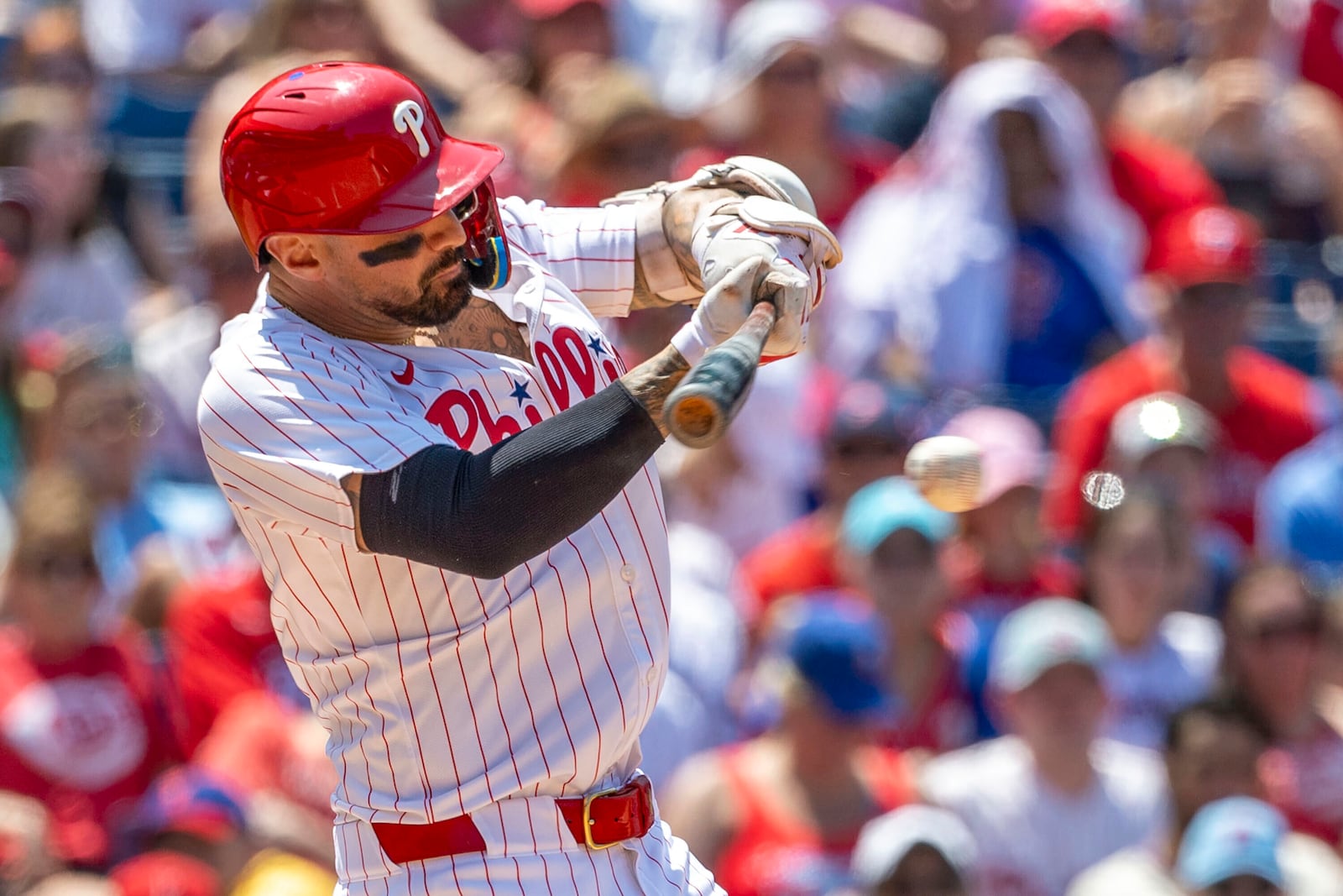 Philadelphia Phillies' Nick Castellanos hits an RBI single in the third inning of a baseball game against the Cincinnati Reds, Friday, July 4, 2025, in Philadelphia. (AP Photo/Laurence Kesterson)