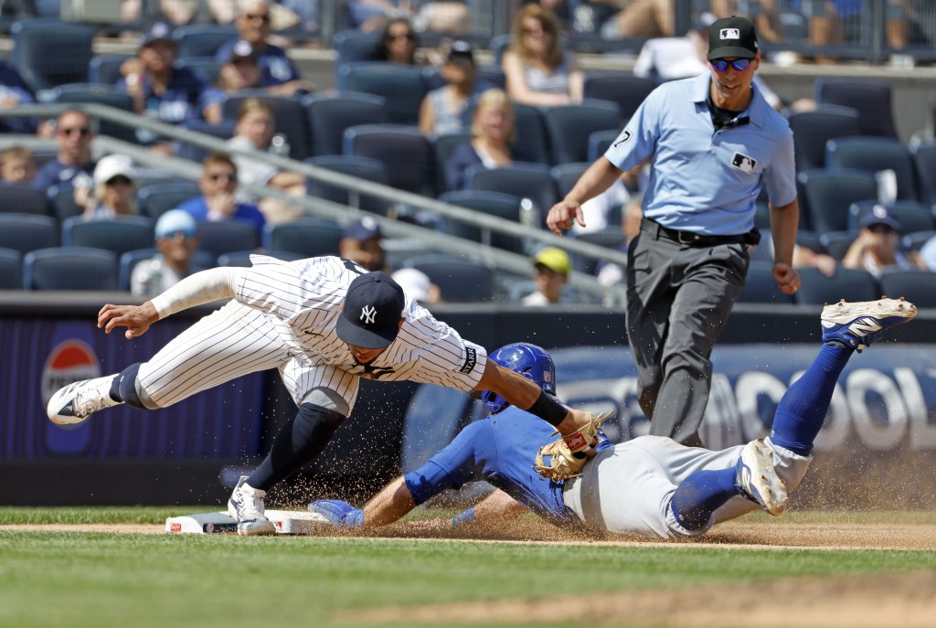 Jon Berti's stolen base attempt fails as he's tagged out by Oswald Peraza during the Yankees' 5-2 loss to the Cubs on July 12, 2025.