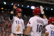 Texas Rangers left fielder Josh Hamilton (32) is congratulated at the plate by Texas Rangers...