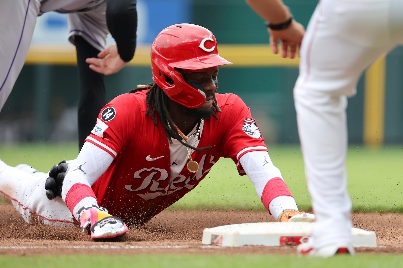 Cincinnati Reds shortstop Elly De La Cruz (44) slides into third base during the first inning of a baseball game against the Colorado Rockies, Saturday, July 12, 2025, in Cincinnati. (AP Photo/Joe Maiorana)