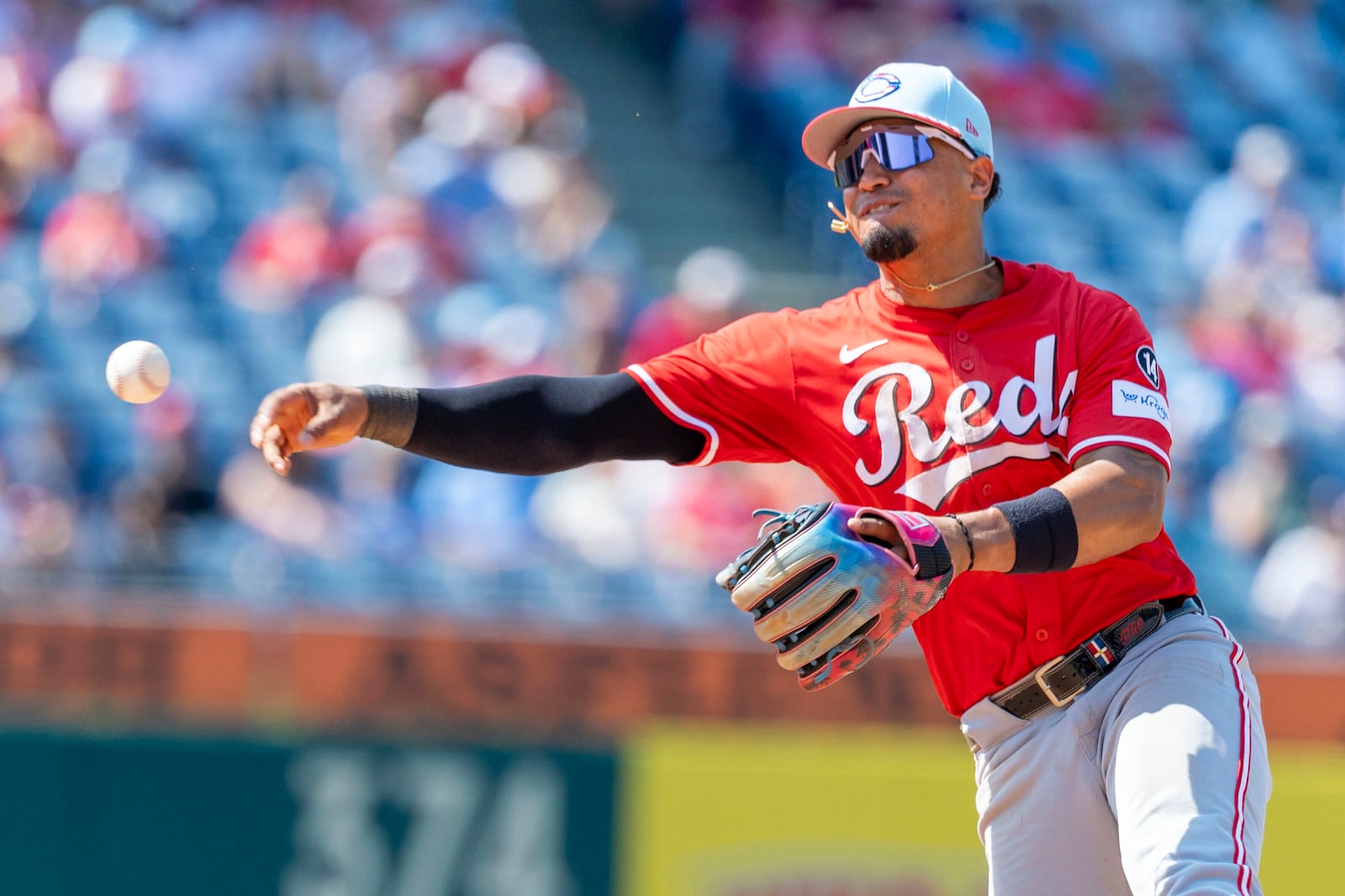 Cincinnati Reds' Santiago Espinal is late on the throw to first base on Philadelphia Phillies' Brandon Marsh's single in the eighth inning of a baseball game, Friday, July 4, 2025, in Philadelphia. (AP Photo/Laurence Kesterson)