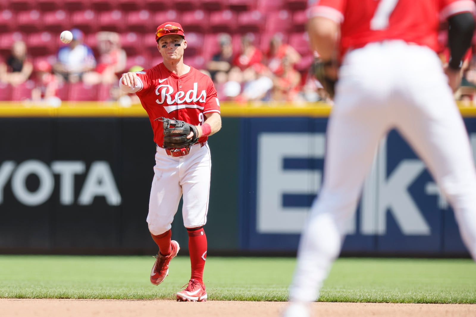 Cincinnati Reds second baseman Matt McLain throw out Colorado Rockies' Mickey Moniak at first base during the seventh inning of a baseball game Sunday, July 13, 2025, in Cincinnati. (AP Photo/Jay LaPrete)
