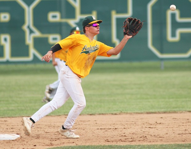 An Amherst infielder makes a catch on a line drive...
