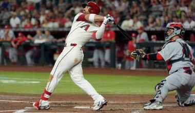 Arizona Diamondbacks' Eugenio Suárez, left, watches the flight of his three-run home run as St. Louis Cardinals catcher Yohel Pozo, right, looks on during the first inning of a baseball game Sunday, July 20, 2025, in Phoenix. (AP Photo/Ross D. Franklin)