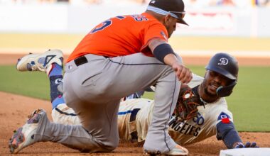 Los Angeles Dodgers' Mookie Betts, right, is tagged out by Houston Astros third baseman Isaac Paredes, left, while trying to stretch for a triple during the seventh inning of a baseball game in Los Angeles, Saturday, July 5, 2025. (AP Photo/Kyusung Gong)