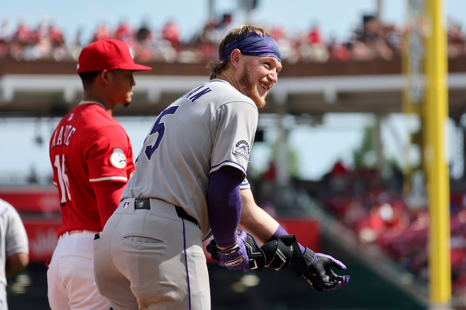 Colorado Rockies' Hunter Goodman (15) celebrates a triple during the fourth inning of a baseball game against the Cincinnati Reds, Saturday, July 12, 2025, in Cincinnati. (AP Photo/Joe Maiorana)
