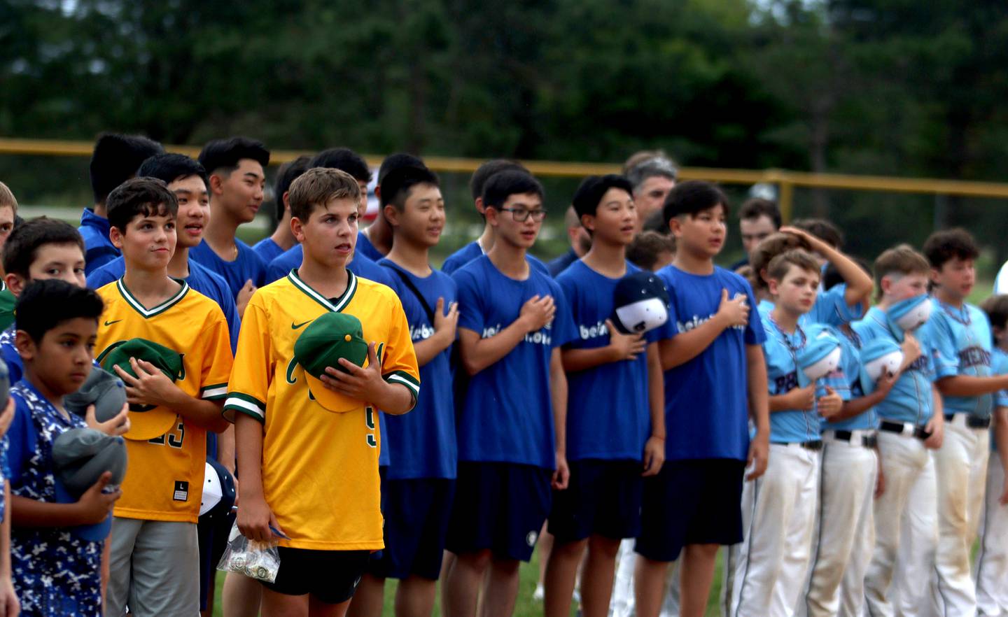 Players observe the playing of the national anthem during MCYSA 2023 Summer International Championships Opening Ceremonies Friday, July 14, 2023, at the Mickey Sund Complex in Lippold Park in Crystal Lake.