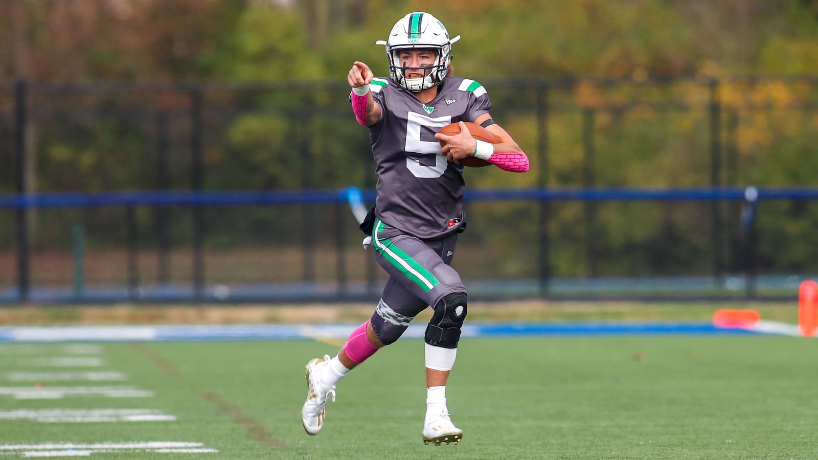 975: Hamilton Badin High School quarterback Landyn Vidourek points to his blockers as he runs out of the pocket during the Rams 35-14 victory over Tippecanoe on Saturday afternoon at Edgewood High School. CONTRIBUTED PHOTO BY MICHAEL COOPER