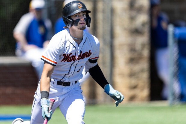 Lincoln-Way West's Conor Essenburg (8) looks up after connecting on a pitch from Sandburg during the Class 4A Sandburg Regional final in Orland Park on Saturday, May 25, 2024. (Vincent D. Johnson/for the Daily Southtown)