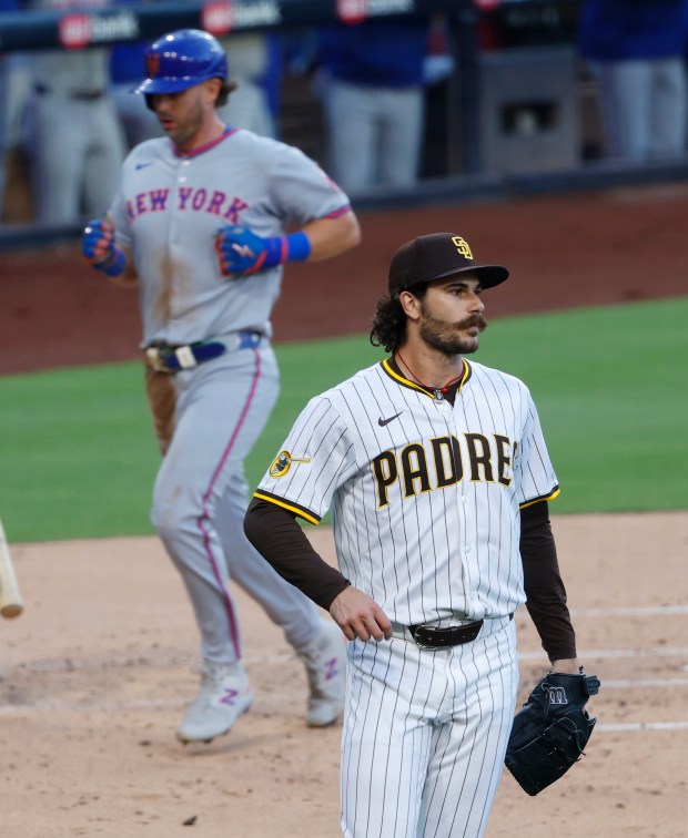 Dylan Cease #84 of the San Diego Padres looks on as Jeff McNeil #1 of the New York Mets scores in the second inning at Petco Park on July 28, 2025 in San Diego, California. (K.C. Alfred / The San Diego Union-Tribune)