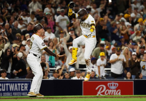 Luis Arraez #4 of the San Diego Padres celebrates with third base coach Tim Leiper after hitting a two-run home run against the New York Mets in the fifth inning at Petco Park on July 28, 2025 in San Diego, California. (K.C. Alfred / The San Diego Union-Tribune)