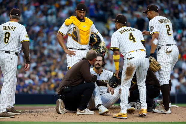 Dylan Cease #84 of the San Diego Padres is looked at after getting hit in the head by a hit by Francisco Lindor #12 of the New York Mets in the third inning at Petco Park on July 28, 2025 in San Diego, California. (K.C. Alfred / The San Diego Union-Tribune)