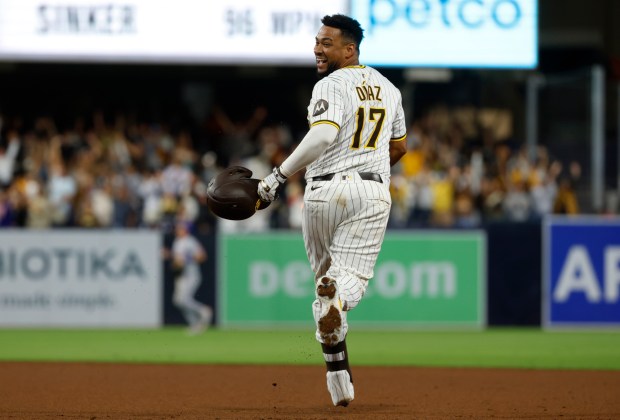 The Padres' Elias Díaz  looks back toward the dugout after his walk-off single on Monday against the Mets. (K.C. Alfred / The San Diego Union-Tribune)