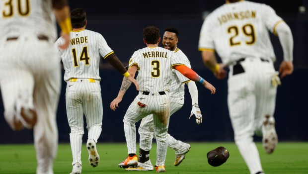 Elias Díaz  celebrates with Jackson Merrill after hitting a walk-off single in the ninth inning to give the Padres a 7-6 victory over the Mets on Monday. (K.C. Alfred / The San Diego Union-Tribune)