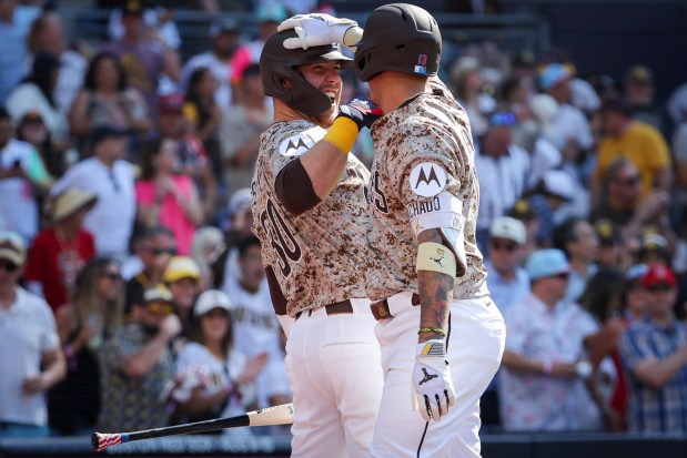 Gavin Sheets #30 and Manny Machado #13 of the San Diego Padres celebrate after Machado's home run against the Texas Rangers during the fourth inning at Petco Park on Friday, July 4, 2025 in San Diego, CA. (Meg McLaughlin / The San Diego Union-Tribune)